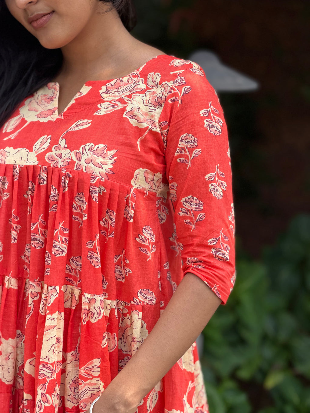 Close-up of hand-block printed fabric on [PBC1006] – red base with cream and black rose motifs