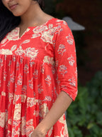 Close-up of hand-block printed fabric on [PBC1006] – red base with cream and black rose motifs