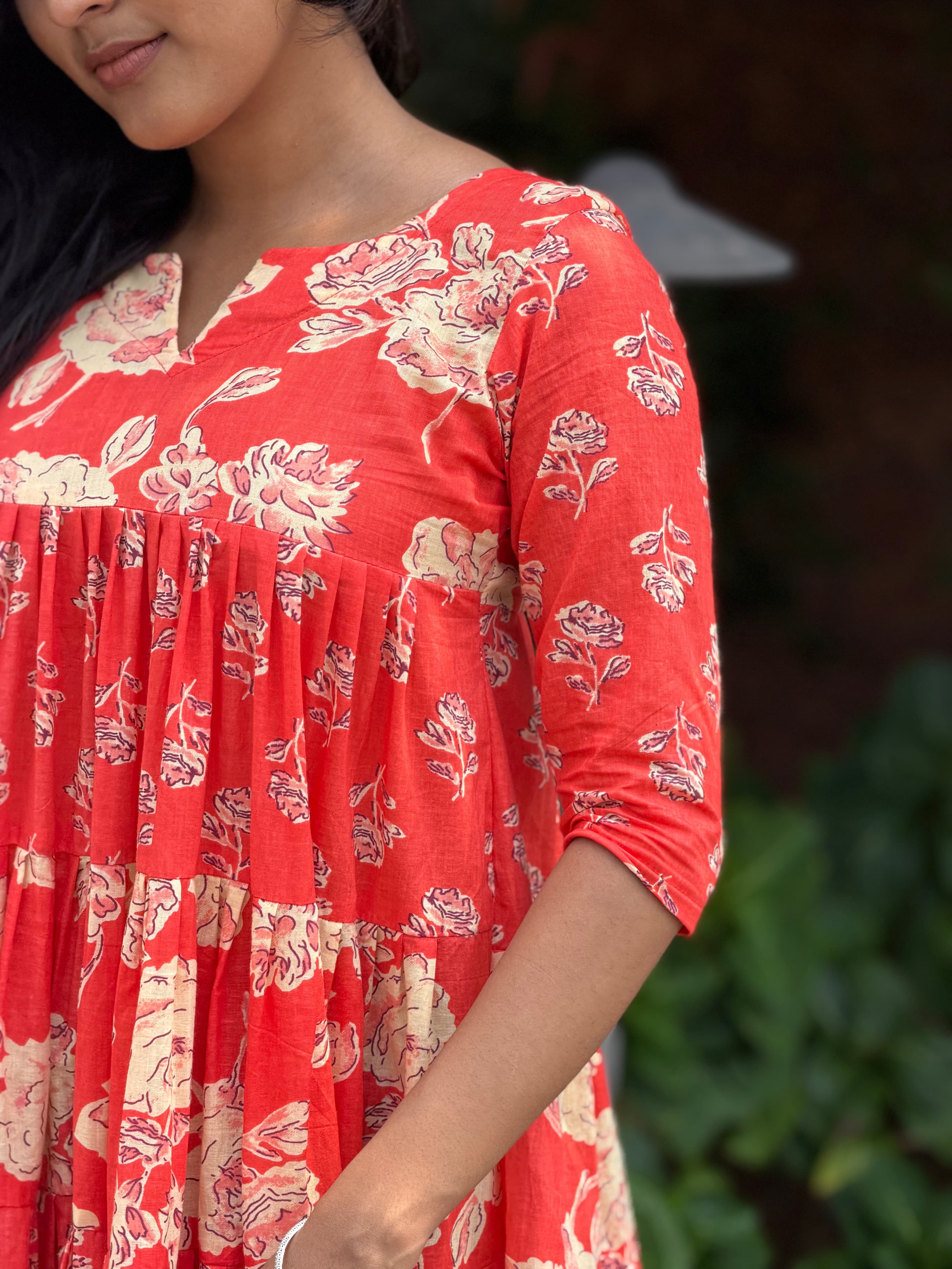 Close-up of hand-block printed fabric on [PBC1006] – red base with cream and black rose motifs