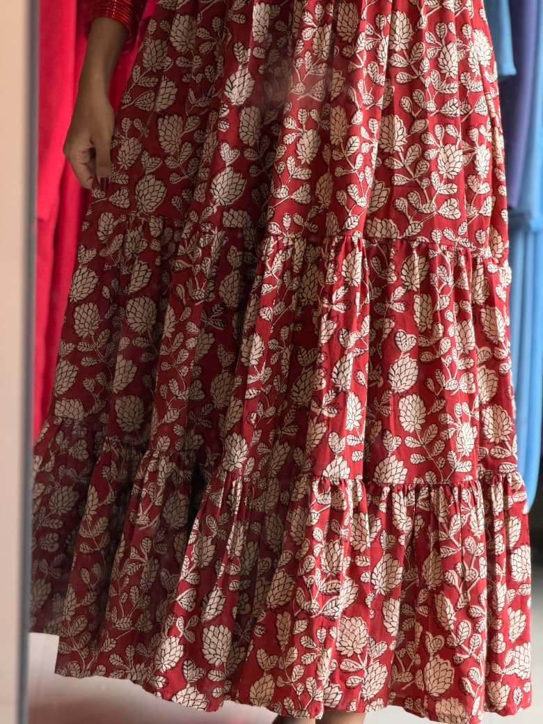 Detail of [PBC1029] – terracotta cotton showing tiered hem and cream lotus block print
