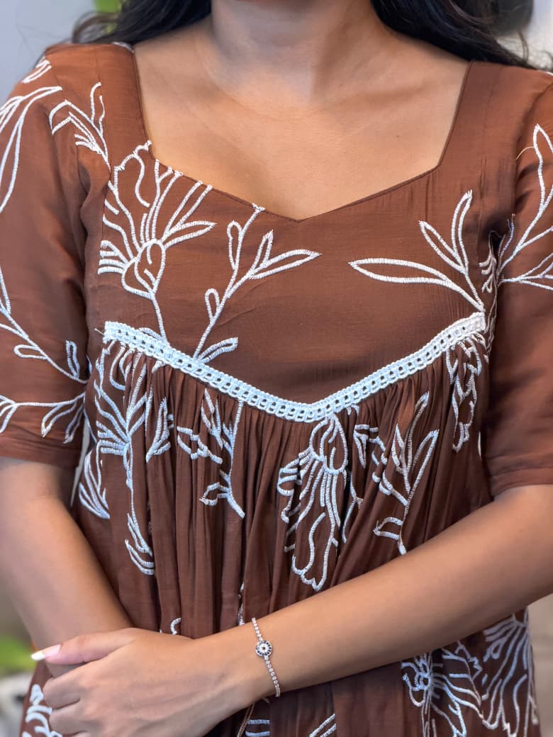 [PBC1039] Rust Brown Floral Outline Mul Chanderi – close-up of the lace-trimmed yoke and white floral outline embroidery