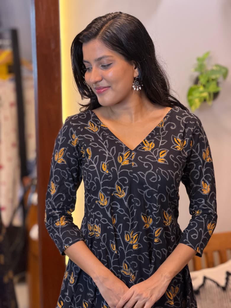 [PBC1048] Black Mustard Lotus Vine Jaipur Soft Cotton – twirling view showing the movement of the skirt