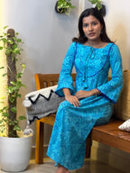 [PBC1054] Turquoise Floral Jaipur Soft Cotton – seated showing the dress drape and floral print
