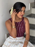 Detail of [PBC1071] maroon bandhani blouse – showing sequin bandhani-dot pattern and gold booti Kasavu skirt border