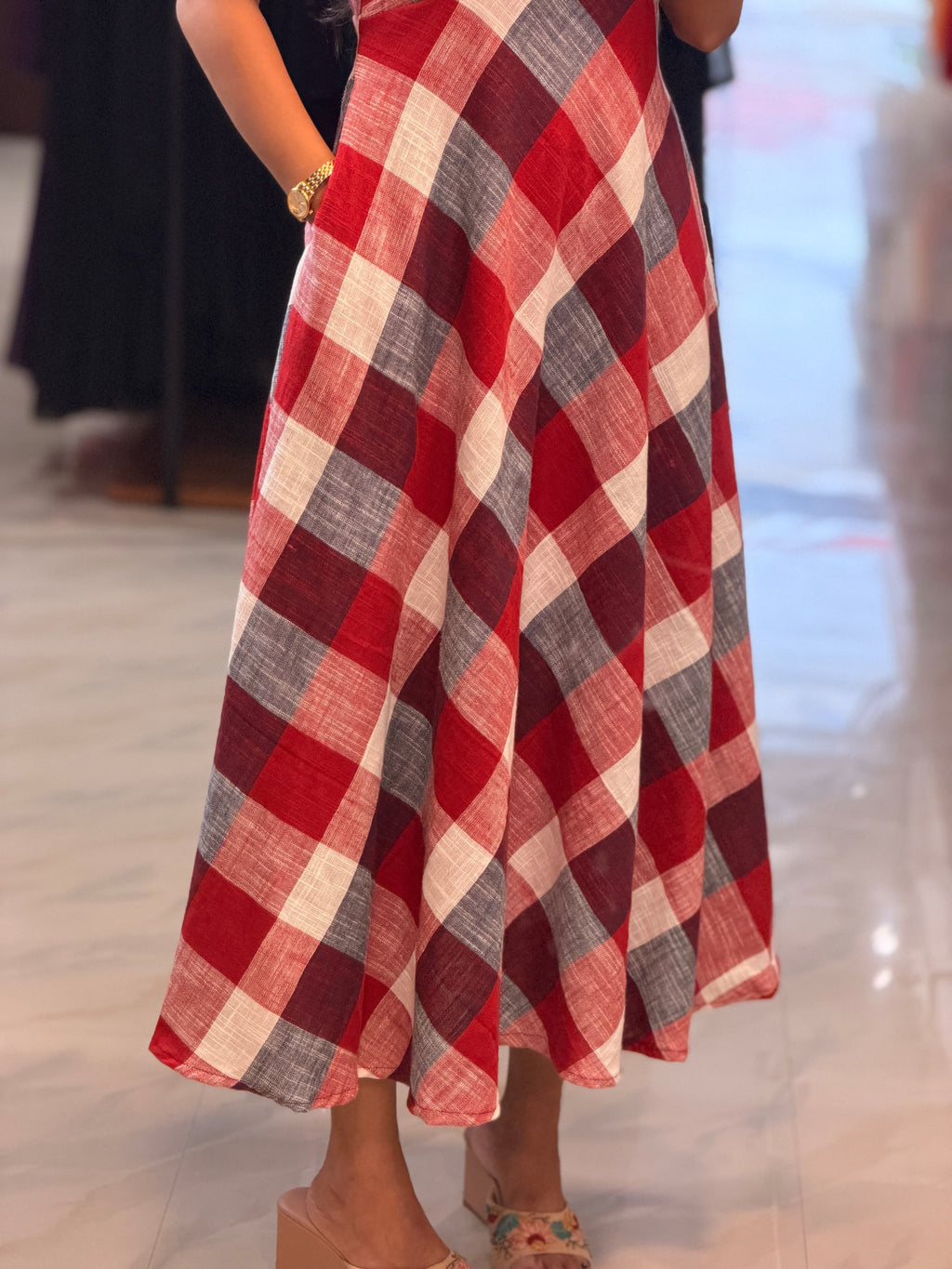 Detail of [PBC1092] Red gingham check Jaipur Soft Cotton – close-up of the gingham check pattern and flared skirt drape
